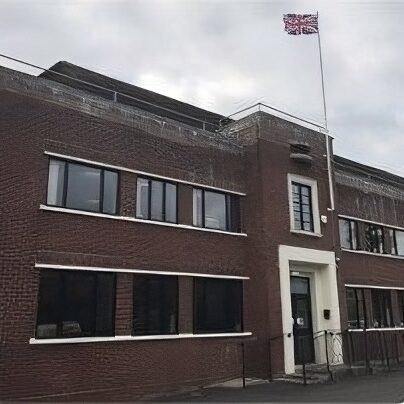 The Tincknell Solar head office with a cloudy sky and the Union Jack flag flying on a pole
